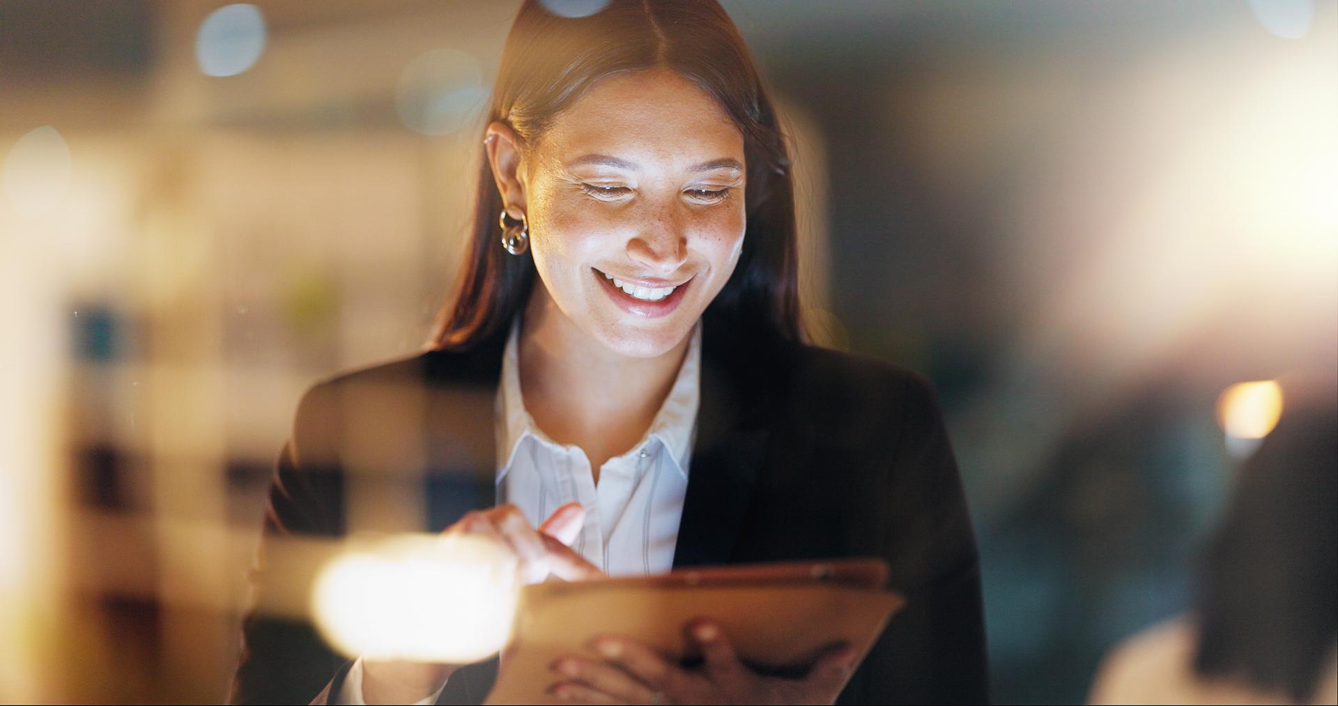 Woman smiling at a clipboard