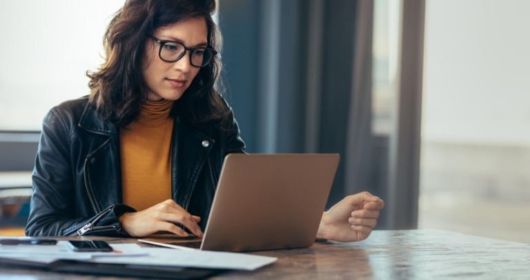 Business woman busy working on laptop computer at office.