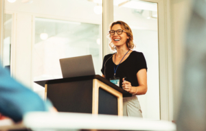 Smiling woman gives presentation.